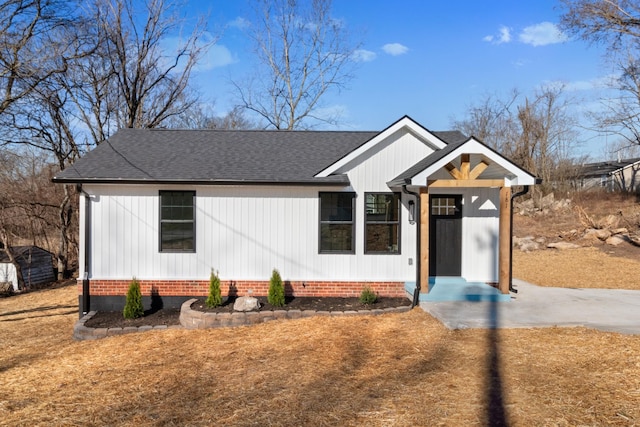 modern farmhouse style home with roof with shingles