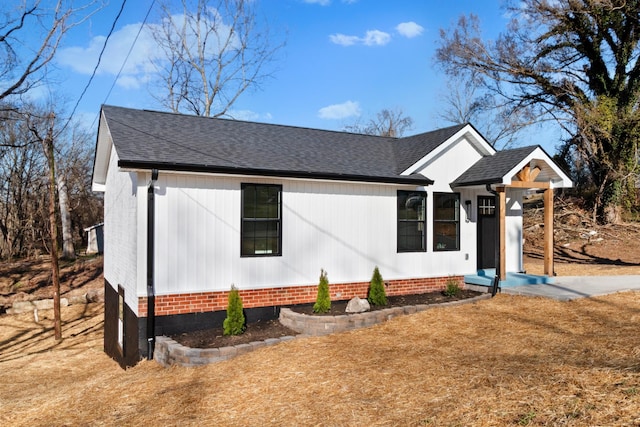 view of front of home featuring roof with shingles