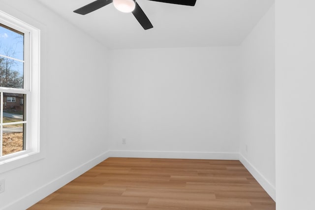 unfurnished room featuring baseboards, ceiling fan, and light wood finished floors