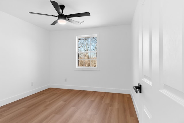 unfurnished room featuring visible vents, light wood-style flooring, a ceiling fan, and baseboards