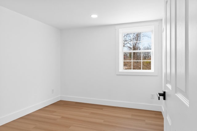 spare room with recessed lighting, light wood-style floors, and baseboards