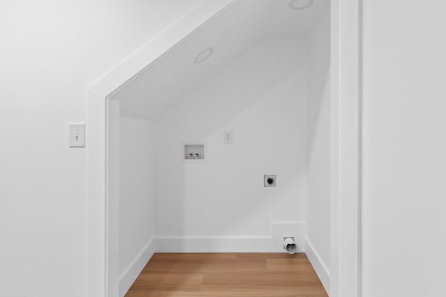 clothes washing area with light wood-type flooring, baseboards, hookup for an electric dryer, and hookup for a washing machine