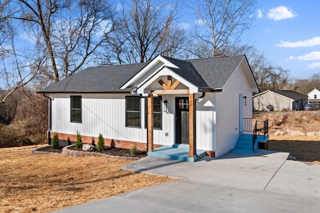 modern farmhouse with board and batten siding and roof with shingles