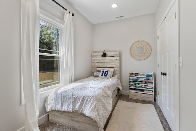 carpeted bedroom with baseboards and visible vents