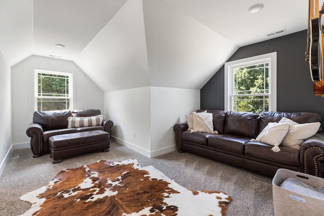 carpeted living room with vaulted ceiling, baseboards, and visible vents