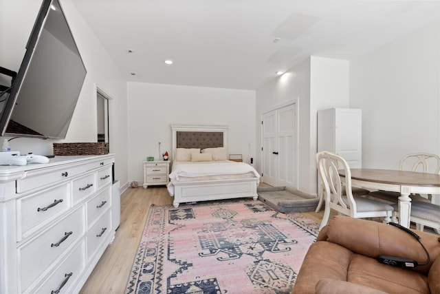 bedroom featuring a closet, recessed lighting, and light wood-type flooring