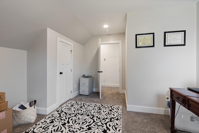 interior space with baseboards, light colored carpet, and vaulted ceiling