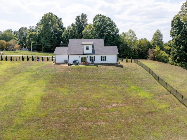 view of front of property with a front lawn and fence