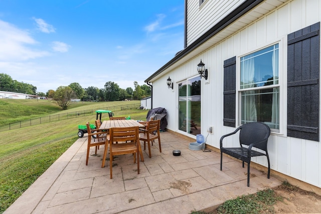 view of patio with outdoor dining area and fence