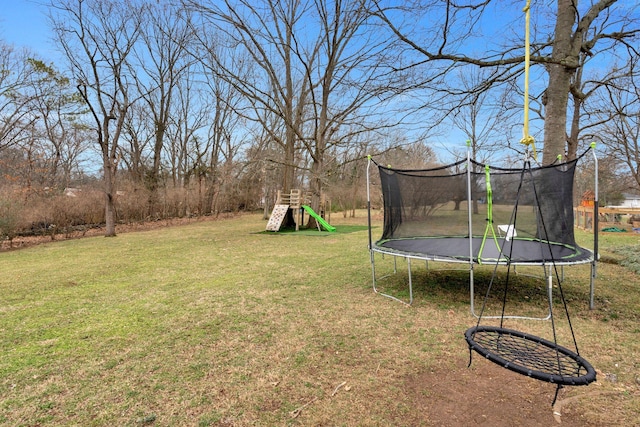 view of yard with a trampoline and a playground