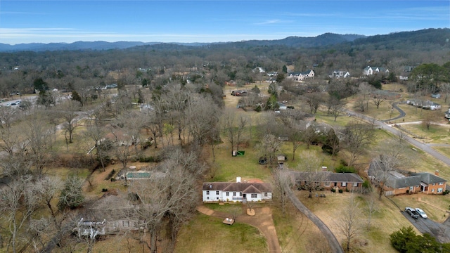 birds eye view of property featuring a mountain view and a wooded view