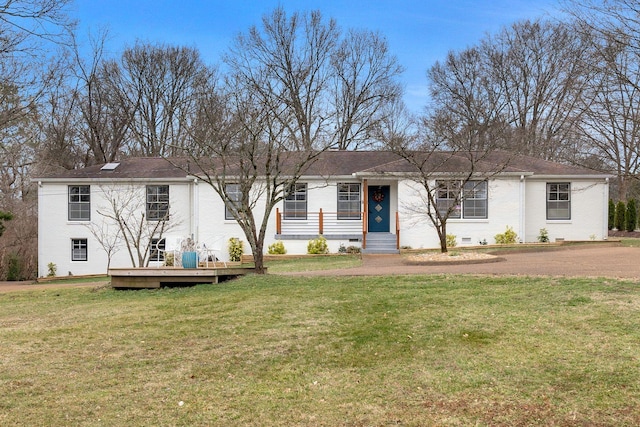 view of front of property featuring a deck, a front lawn, brick siding, and crawl space