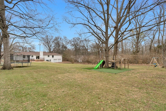 view of yard featuring a trampoline and a playground