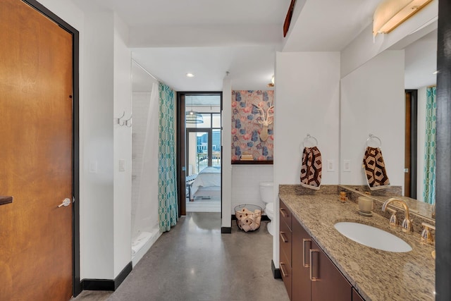 bathroom featuring concrete flooring, recessed lighting, a stall shower, ensuite bath, and vanity