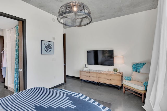 bedroom with baseboards and finished concrete floors