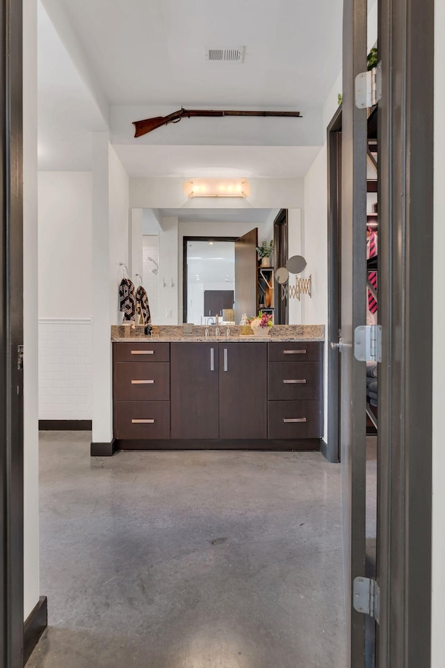 bathroom featuring visible vents, vanity, and concrete floors