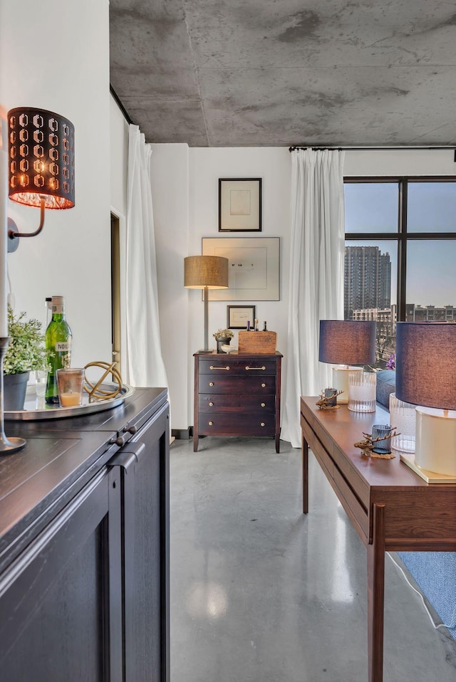 bedroom featuring a city view and concrete floors