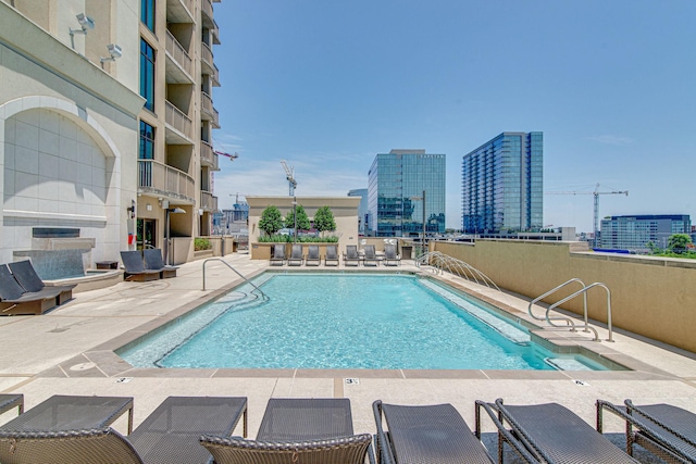 community pool featuring a view of city and a patio