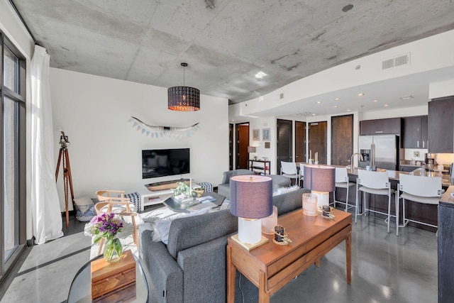 living room featuring visible vents and finished concrete floors