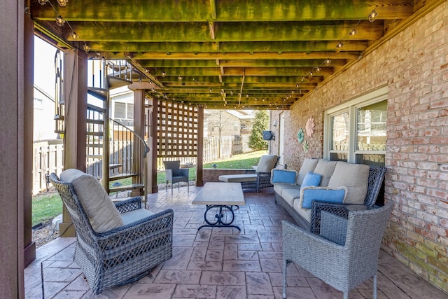 view of patio featuring stairway, outdoor lounge area, and fence