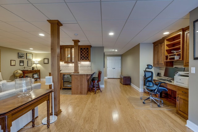 office area with baseboards, recessed lighting, built in study area, and light wood-style floors