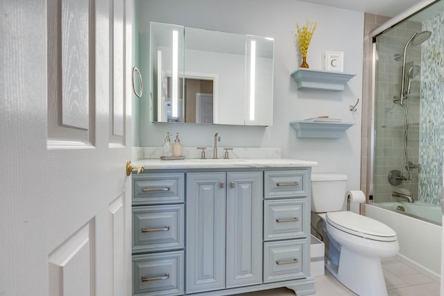 full bath with shower / bath combination with glass door, toilet, vanity, and tile patterned flooring