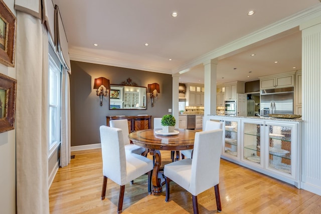 dining room featuring crown molding, light wood-style flooring, and recessed lighting