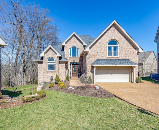 view of front of home with a front yard, roof with shingles, concrete driveway, a garage, and brick siding