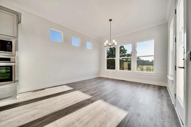 unfurnished dining area with a chandelier, dark wood-type flooring, and baseboards