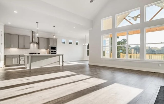 living room featuring high vaulted ceiling, a ceiling fan, dark wood finished floors, recessed lighting, and baseboards