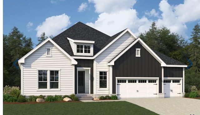 view of front of property featuring board and batten siding, concrete driveway, a front yard, roof with shingles, and an attached garage