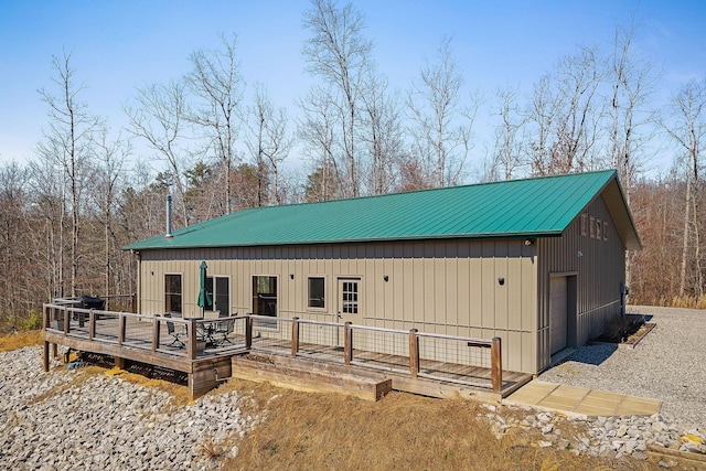 exterior space featuring metal roof and a deck