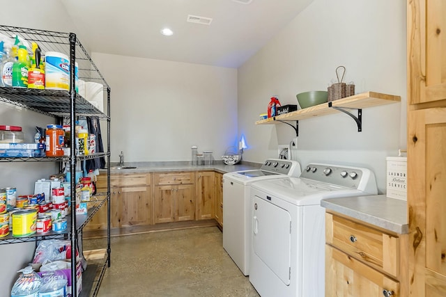 washroom featuring visible vents, recessed lighting, separate washer and dryer, cabinet space, and a sink