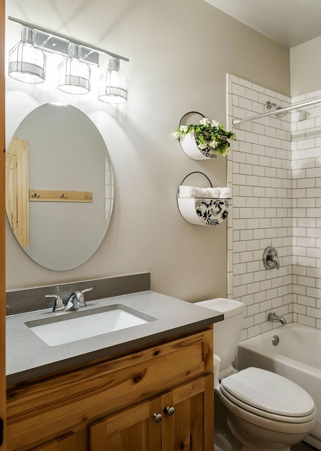 bathroom featuring toilet, vanity, and washtub / shower combination