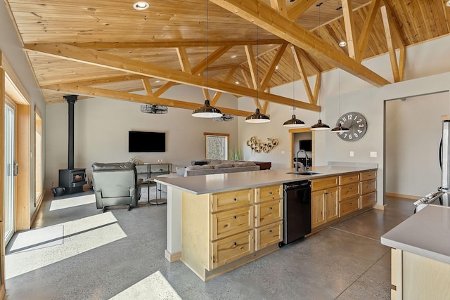 kitchen with a wood stove, finished concrete floors, light brown cabinetry, a sink, and dishwasher