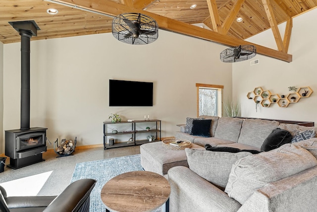 living area featuring high vaulted ceiling, wooden ceiling, and a wood stove