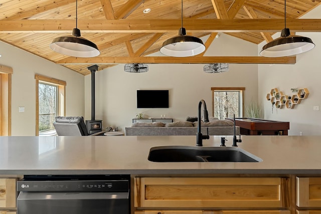 kitchen with a sink, wood ceiling, open floor plan, dishwasher, and a wood stove