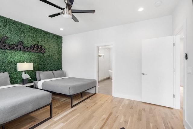 bedroom featuring recessed lighting, light wood-style floors, ceiling fan, and an accent wall