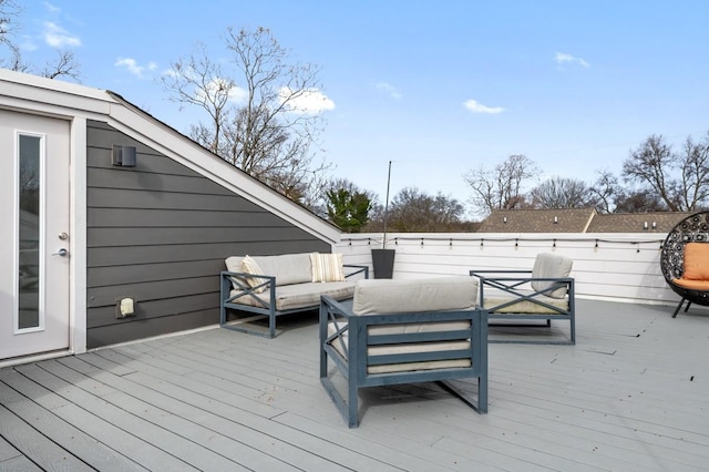 wooden terrace with an outdoor hangout area