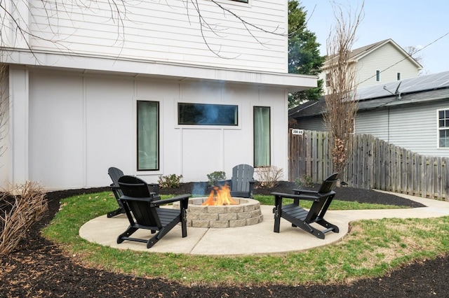 view of patio featuring fence and an outdoor fire pit