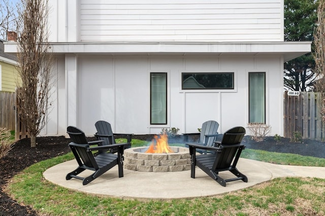 view of patio / terrace with an outdoor fire pit and fence