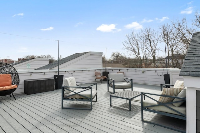 wooden terrace with an outdoor living space