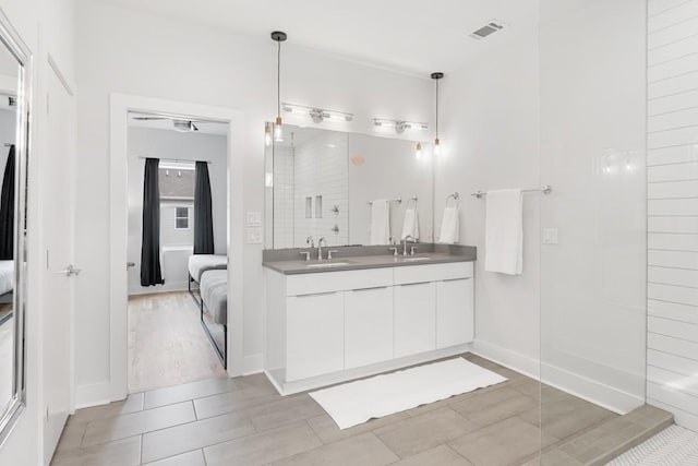 ensuite bathroom with visible vents, ensuite bathroom, and a sink