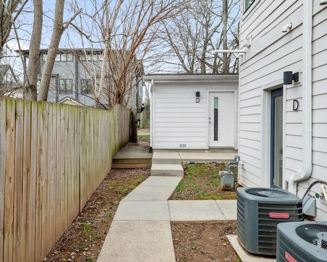 view of yard featuring central air condition unit and fence