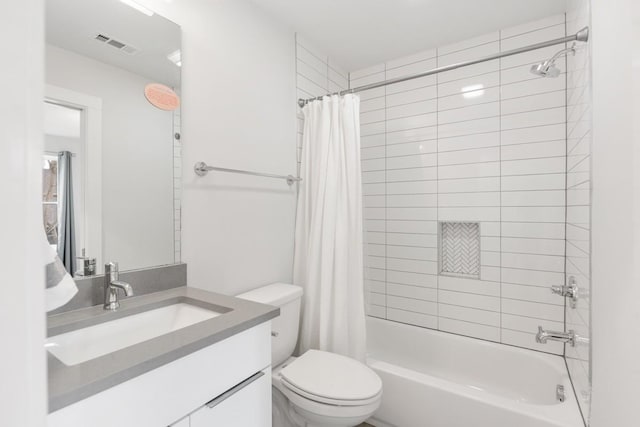 bathroom with visible vents, toilet, vanity, and shower / bathtub combination with curtain