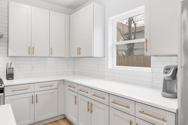 kitchen with light countertops, light wood-style floors, and tasteful backsplash