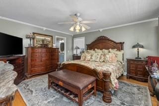 bedroom with crown molding, ceiling fan, and wood finished floors