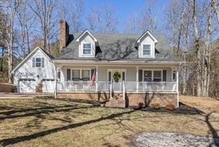 view of front of house with a garage and a porch