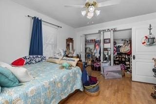 bedroom with a ceiling fan and wood finished floors