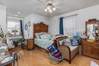 bedroom with light wood finished floors and a ceiling fan